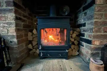 black wood burner near brown brick wall