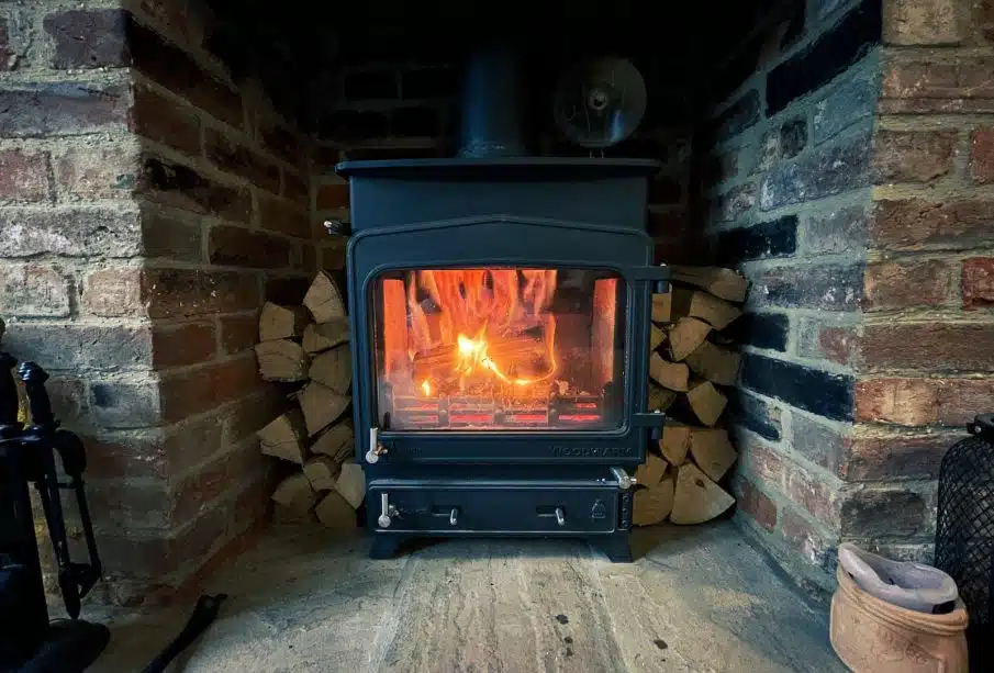 black wood burner near brown brick wall